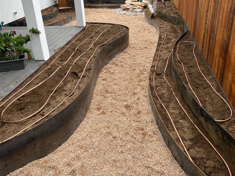 Water-wise irrigation system installed in landscaped beds in Austin